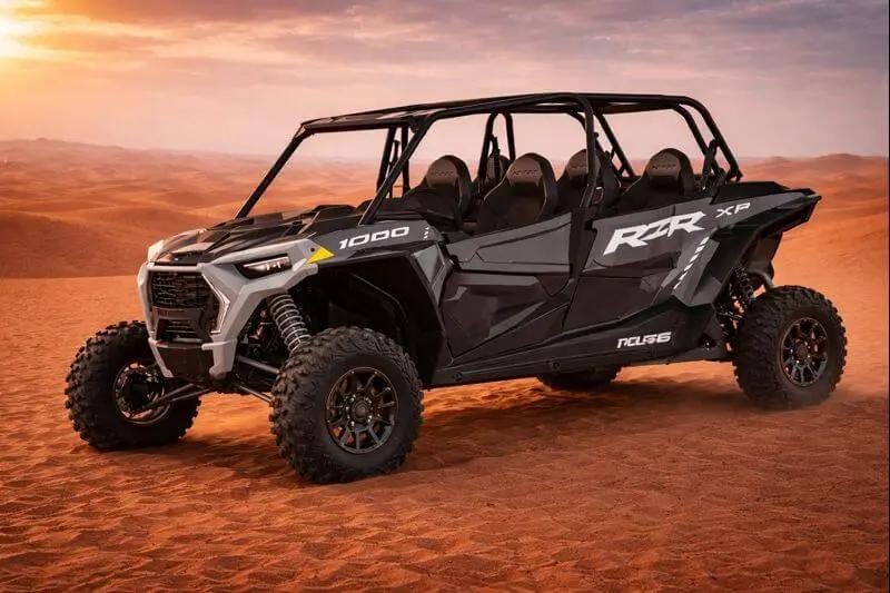 4-seater Polaris buggy parked on the dunes at sunset