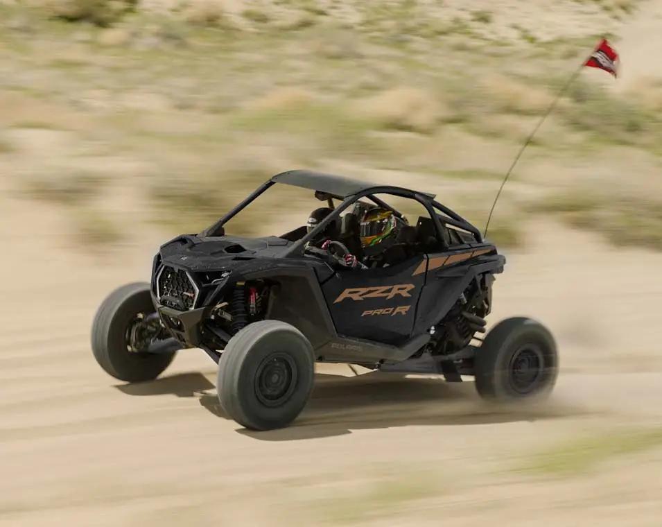 Tour group with safety gear beside a Polaris buggy