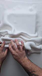 Clay sculpture shaped like flowing waves