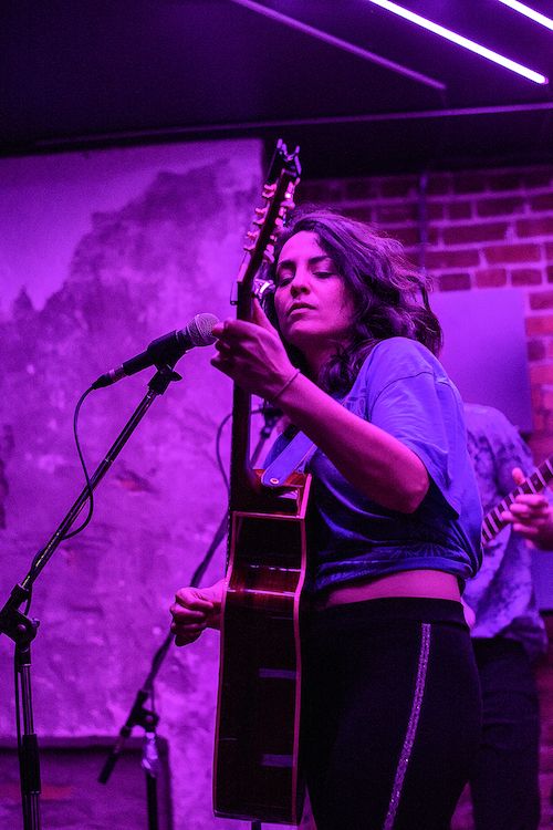 Naghmeh singing and playing the guitar
