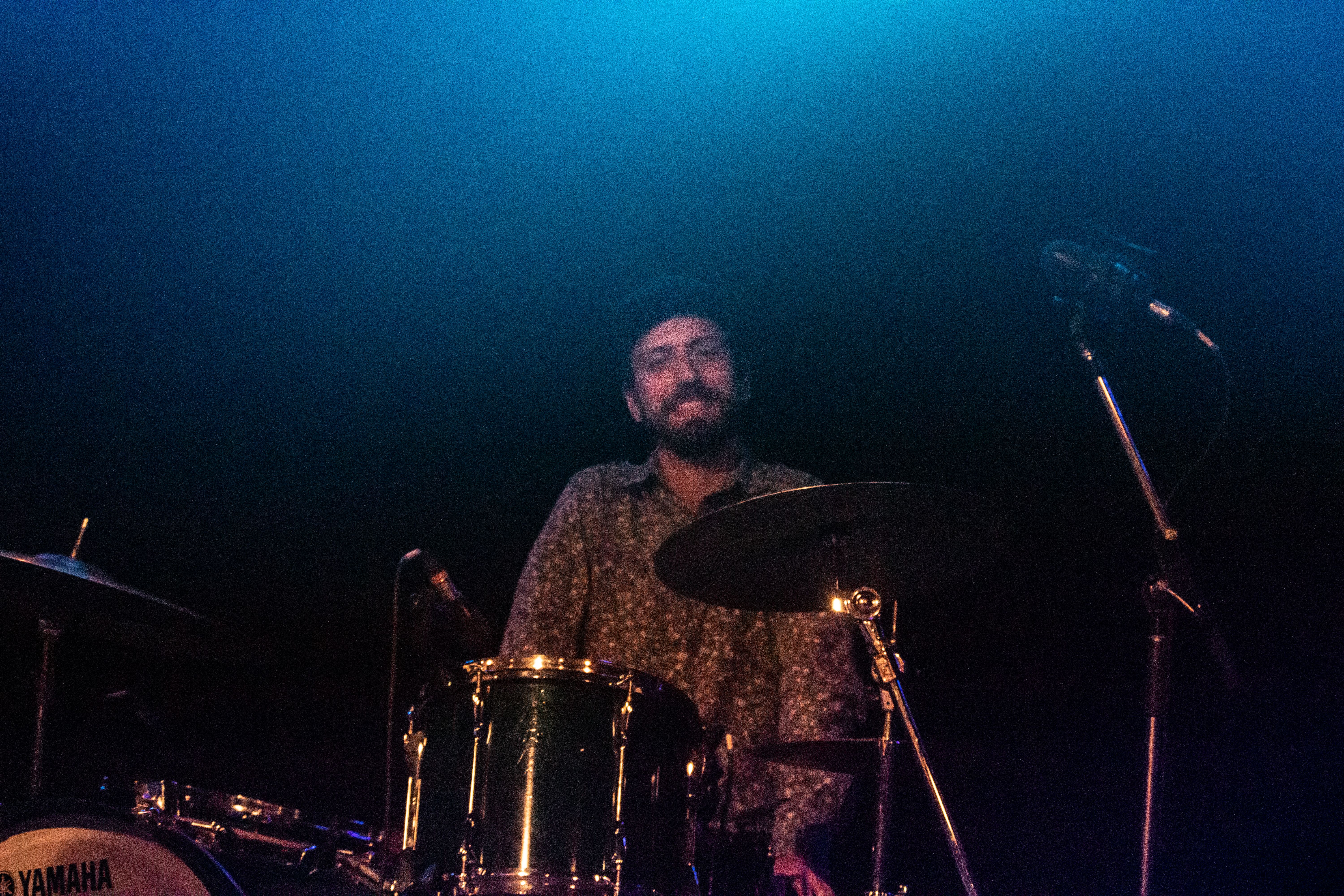 Kevin smiling from behind the drum kit