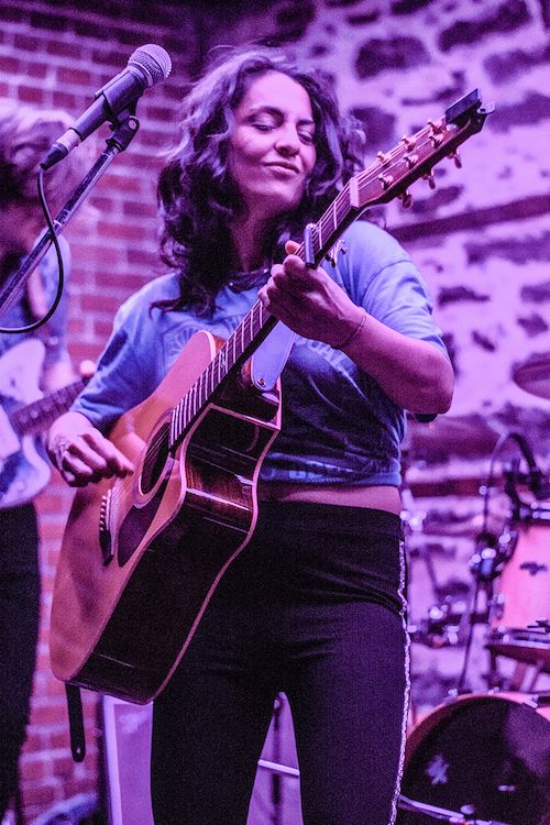 Naghmeh singing and playing the guitar
