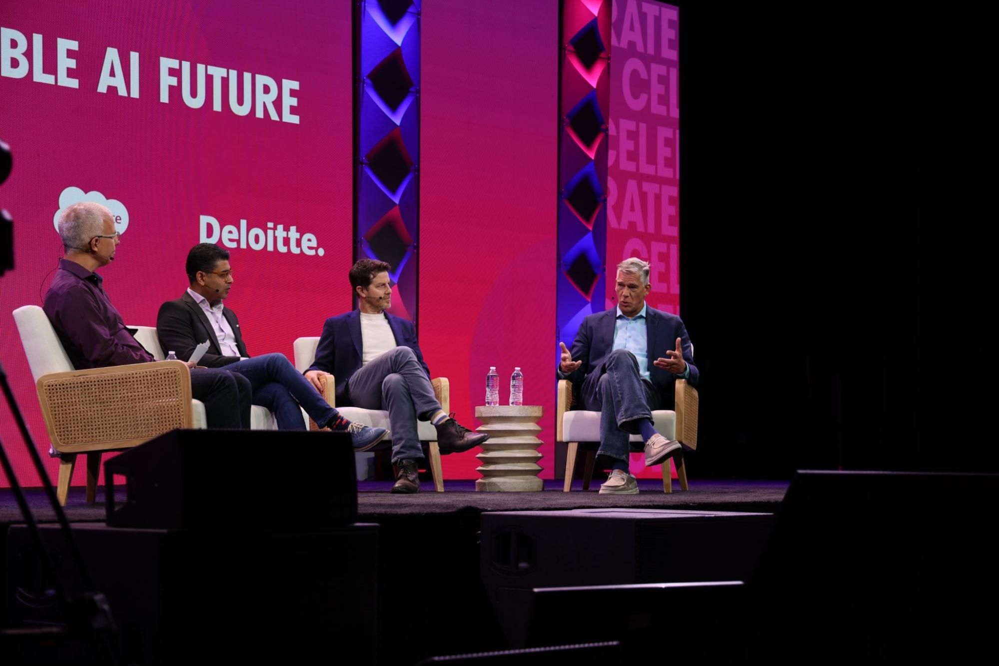 Four people sit on a stage