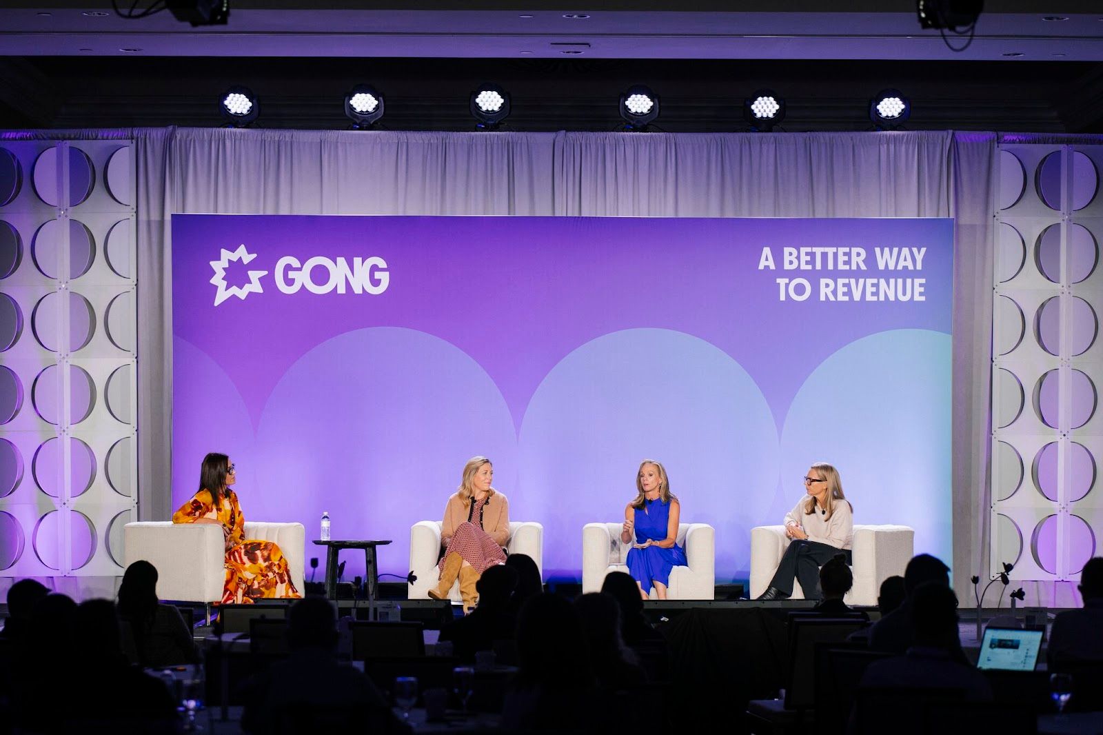 Four women panelists seated on stage at Gong's Celebrate '24 event discussing revenue strategy.