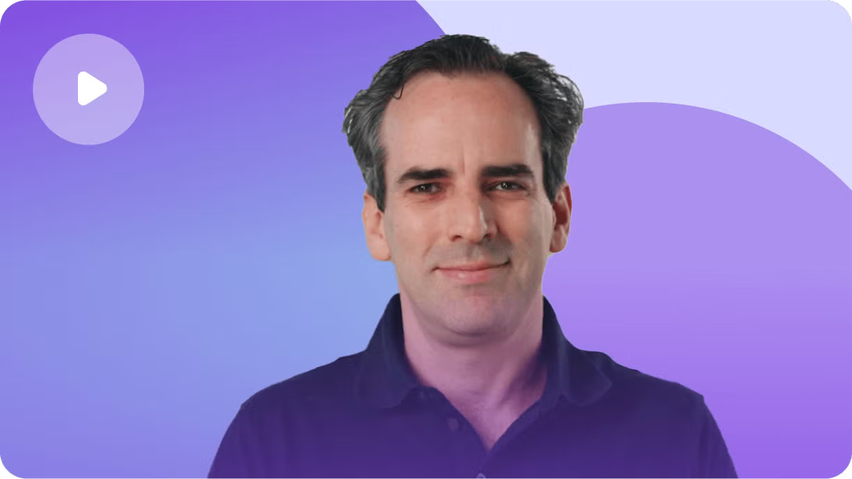 Professional headshot of man in dark purple shirt against purple gradient background