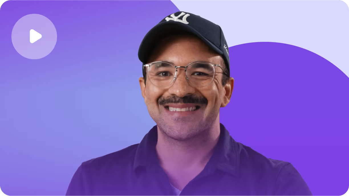 Smiling man wearing glasses and black cap on purple background