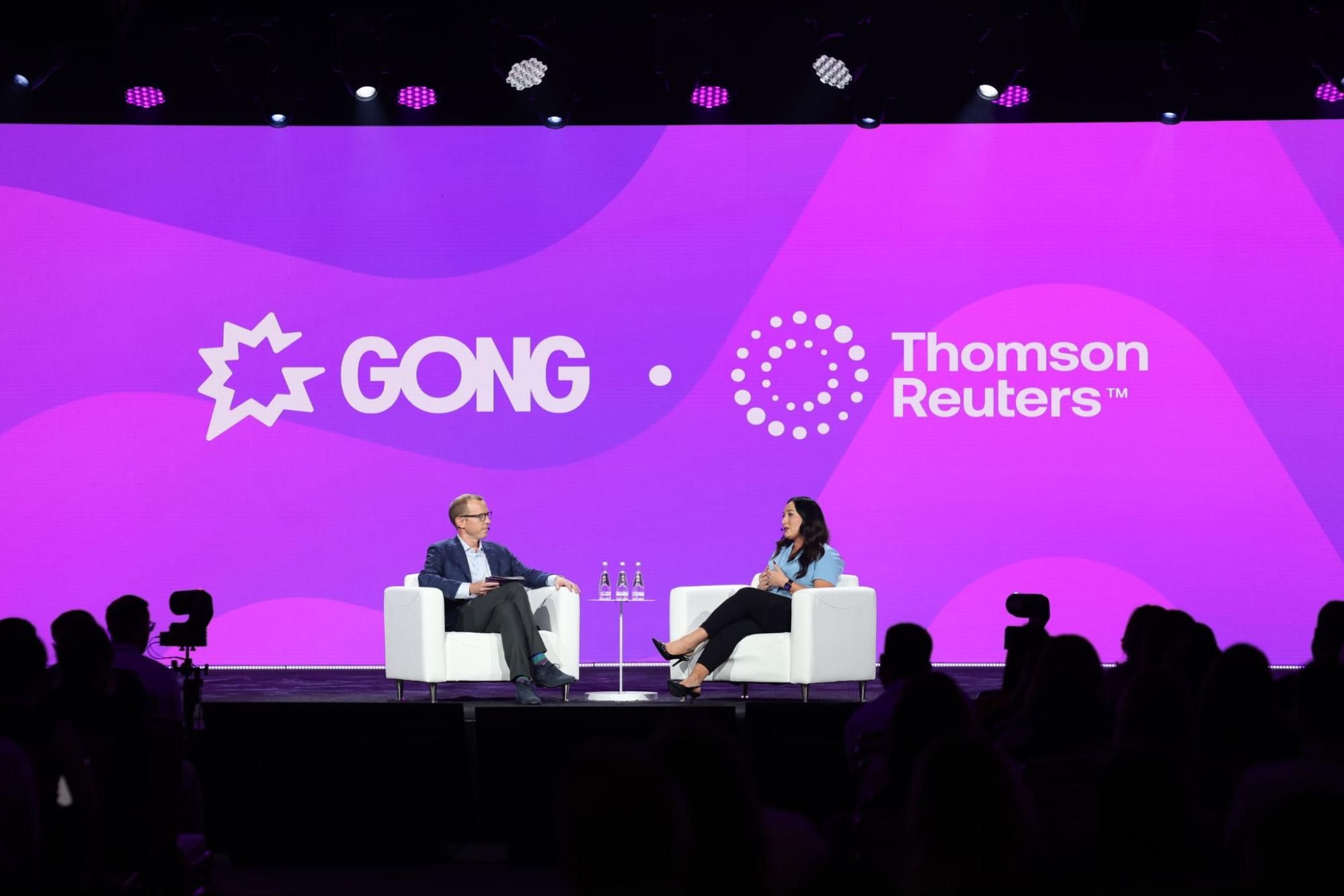 Someone from Gong and someone from Thomson Reuters sit on a stage