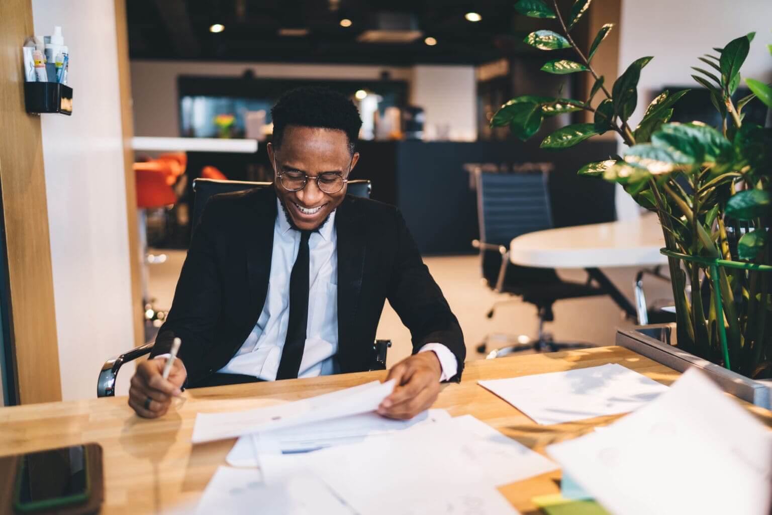 Man sitting at desk with papers in front of him