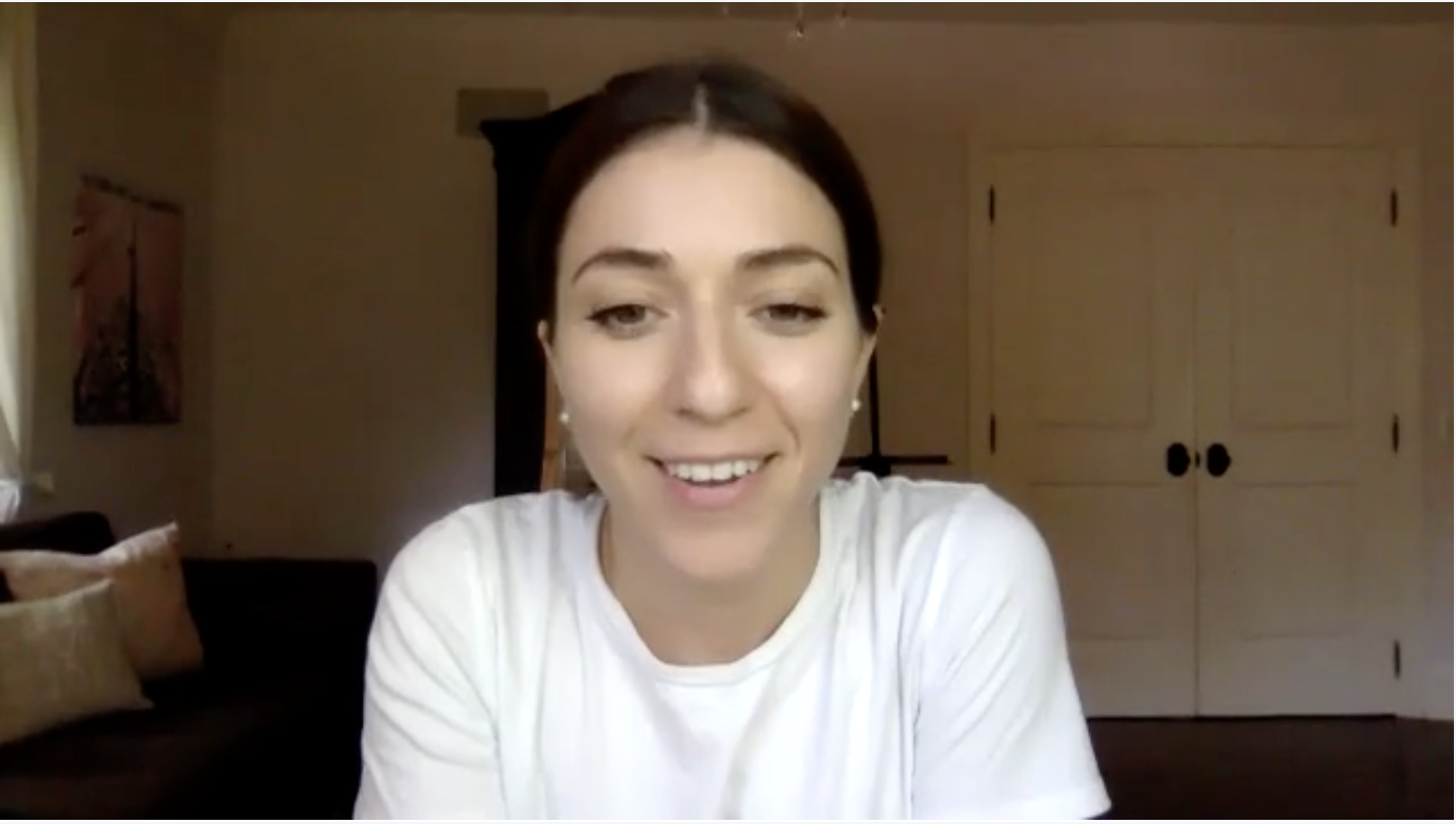 Woman smiling during video call in home office