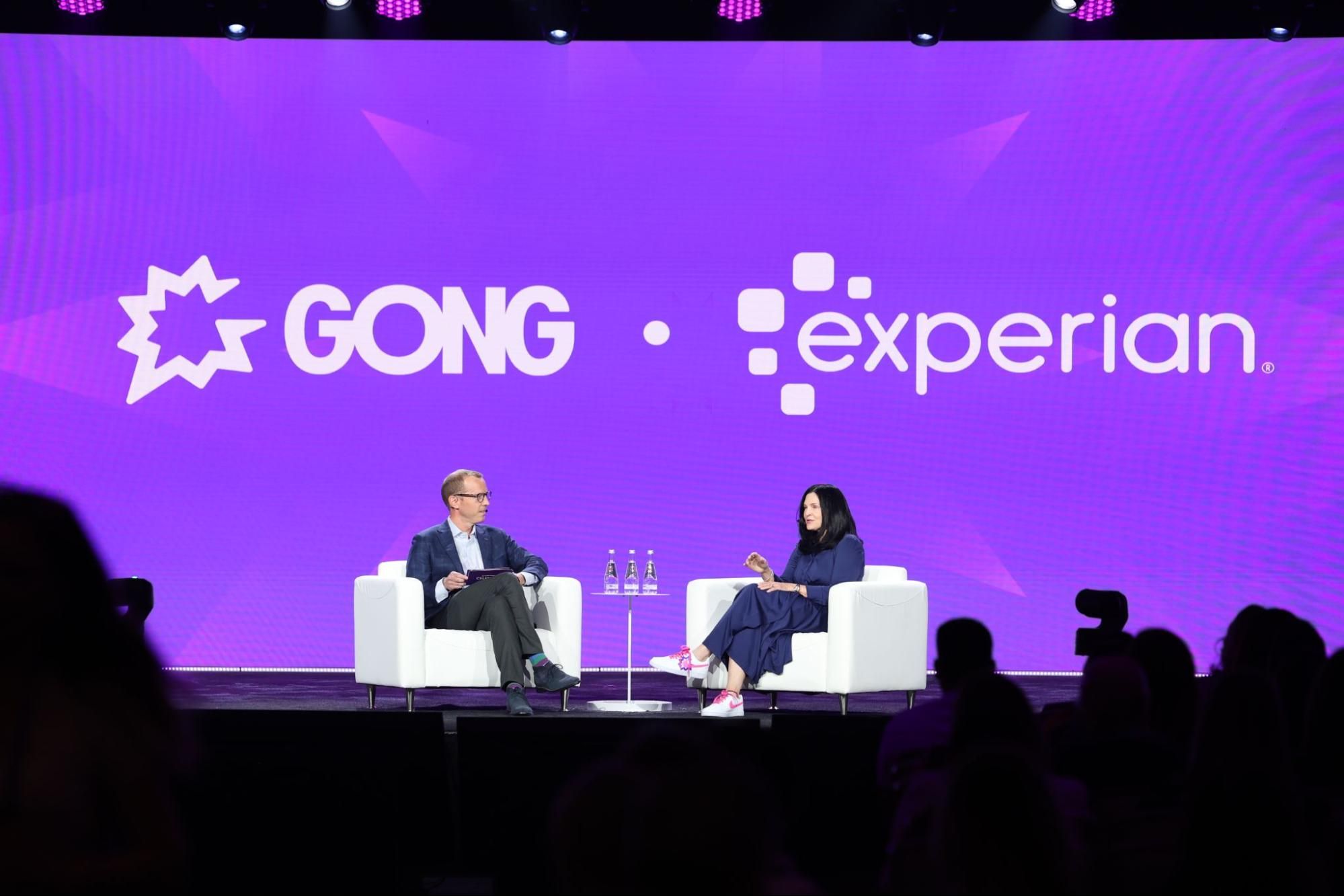Someone from Gong and someone from Experian sit on a stage