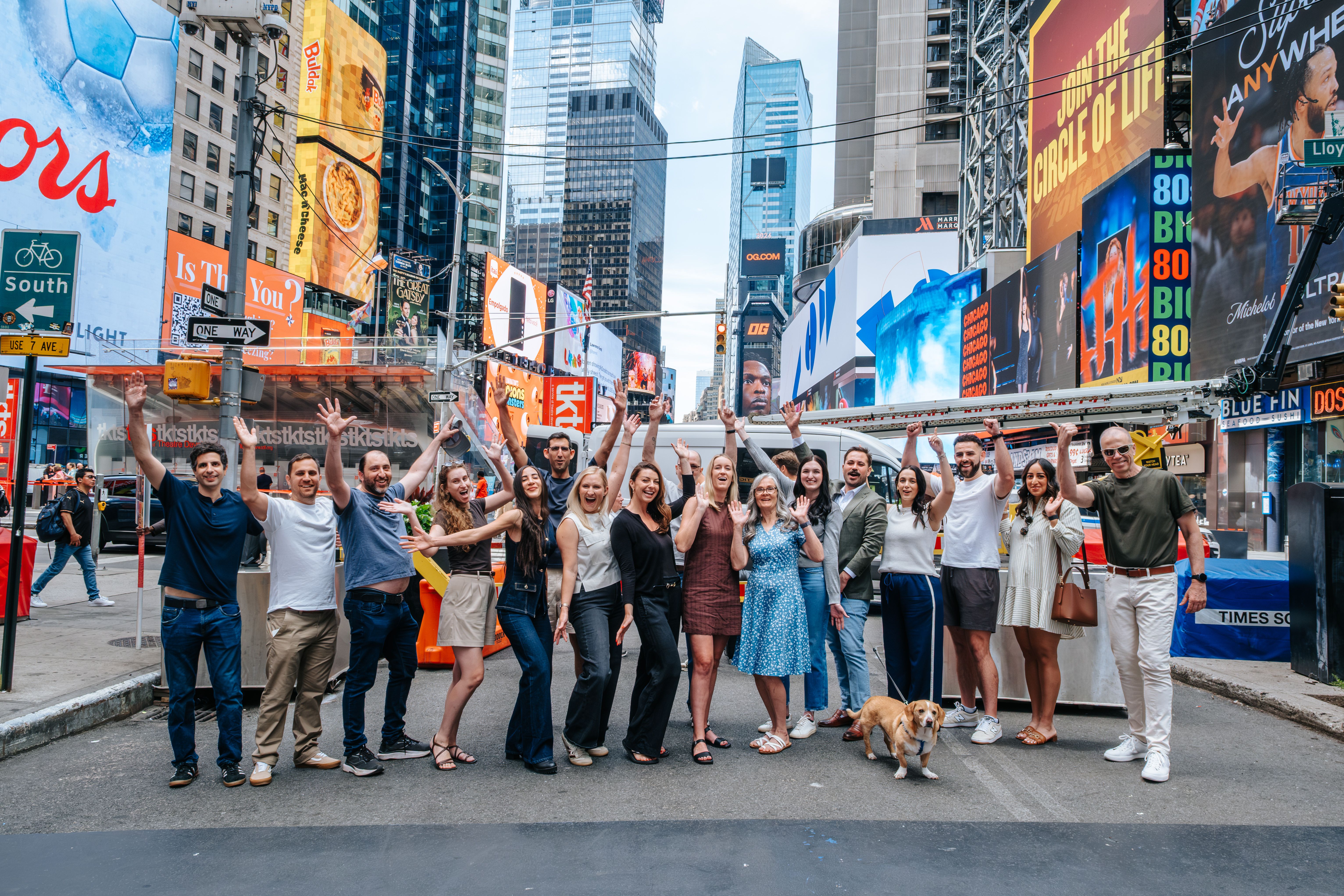 Group of people posing together in Times Square