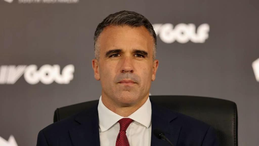 Premier Peter Malinauskas voor een achtergrond met het LIV Golf-logo