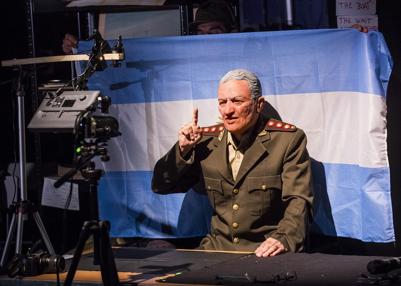 From the production Minefield, a man in general costume pointing in front of an Argentinian flag