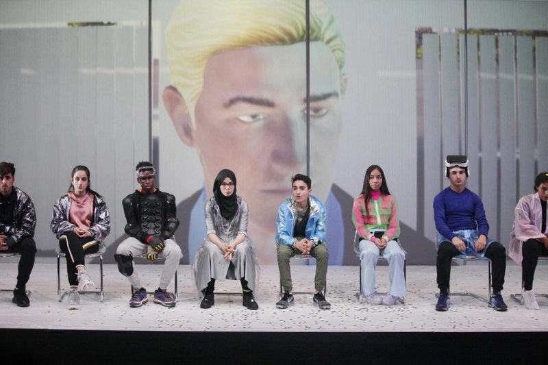 From Futureland, eight young people sitting on chairs with different outfits