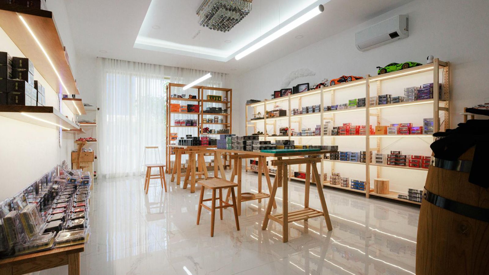 A brightly lit specialty retail showroom with boxed products arranged on wooden shelving.