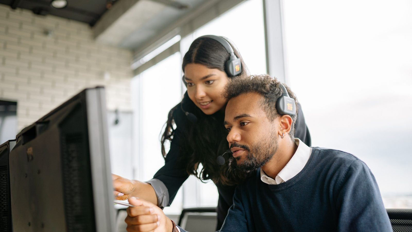 An IT support team working at desks in an office