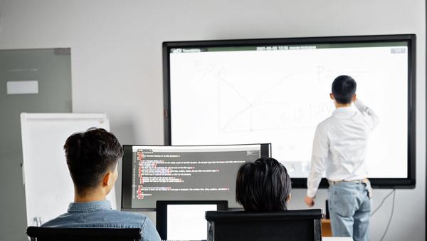 A team reviewing a software rollout during a presentation in a modern office
