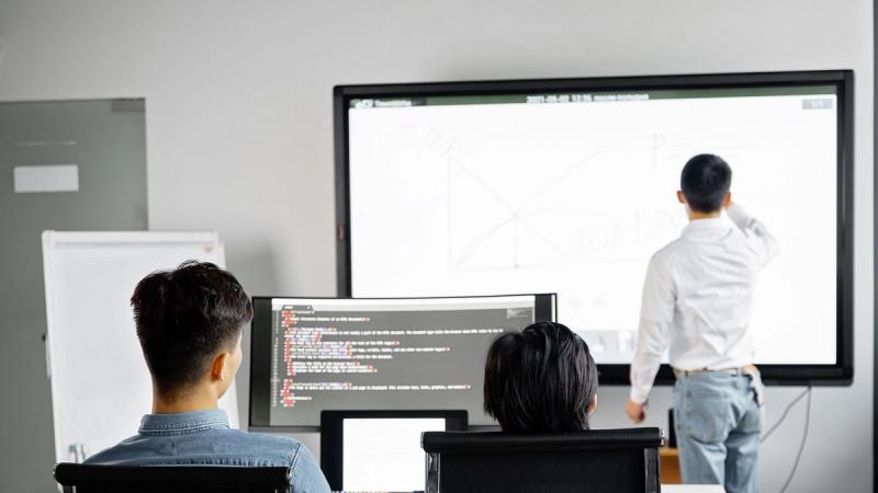 A team reviewing a software rollout during a presentation in a modern office