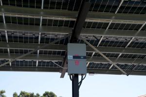 Image from underneath a car port of the connections for solar panels