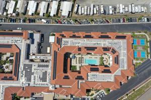 Aerial image of a senior living facility with solar panels on the roof and car ports