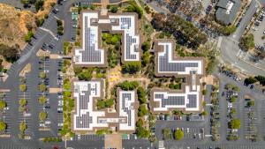 Aerial view of a commercial building with solar panels on its roof