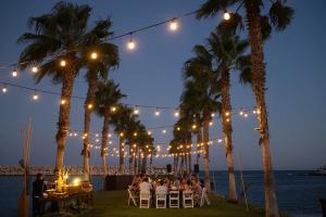 Table on the waterfront with twinkle lights above it