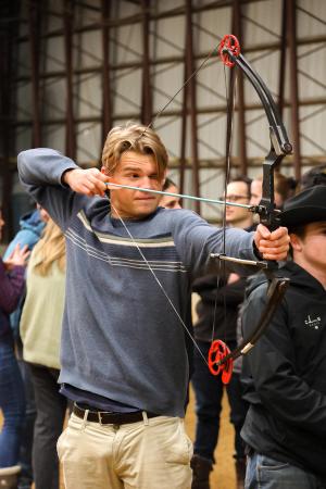 Man holding and aiming an archery bow