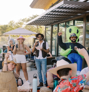 People in costumes smiling outside