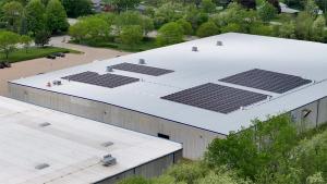 A warehouse with solar panels on its roof