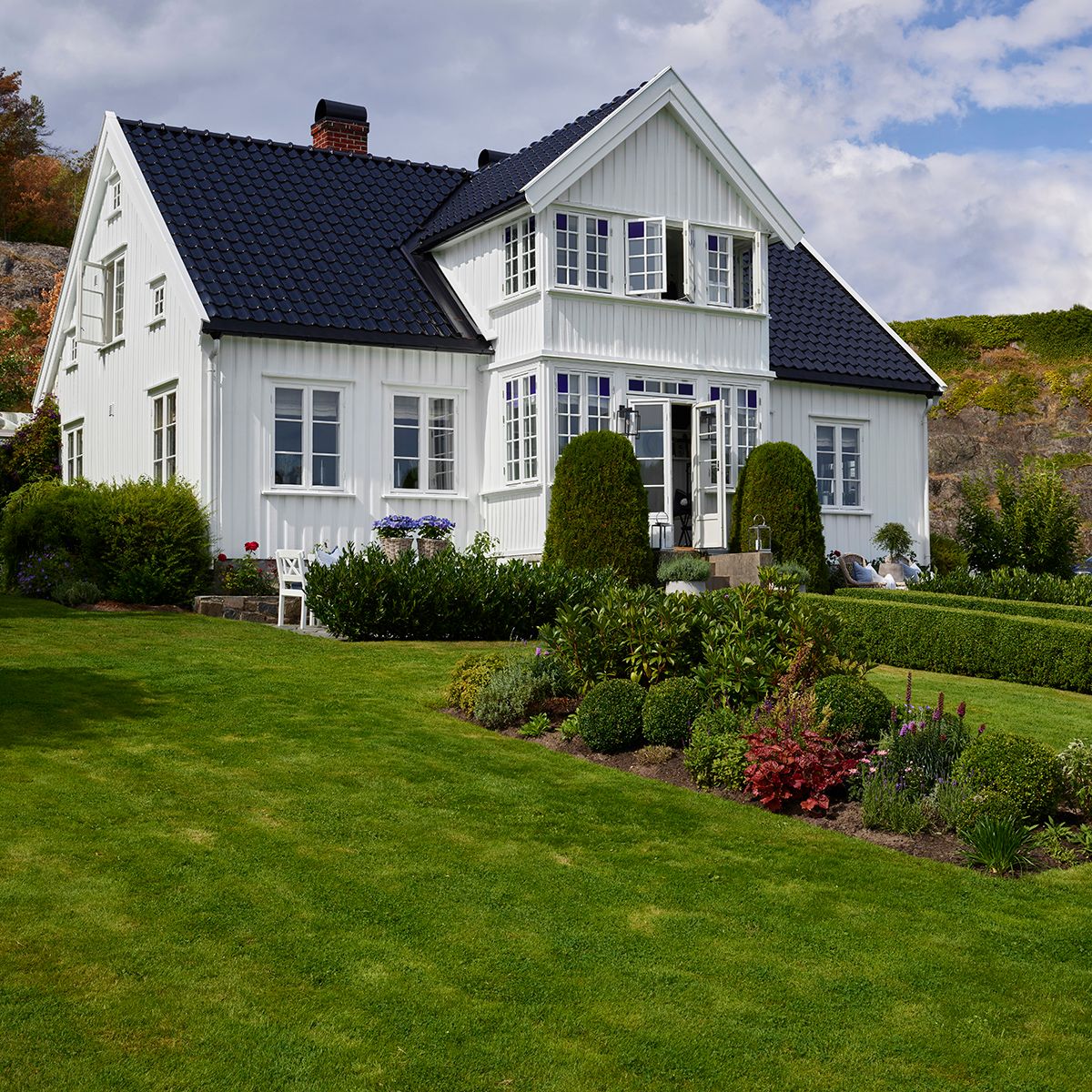 Hvitt hus med hage og blomster