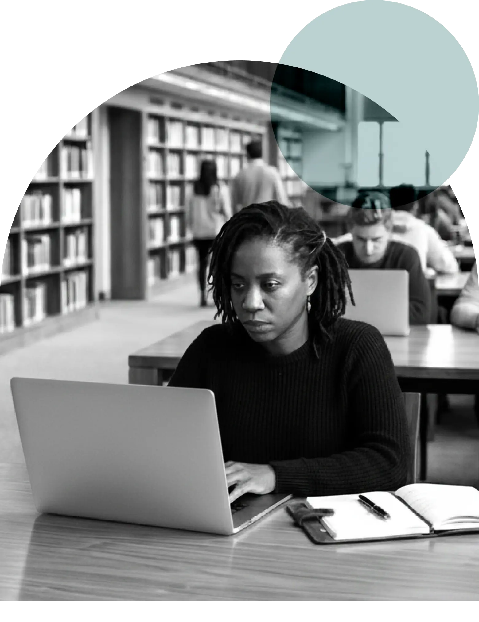 Woman in library typing on a computer