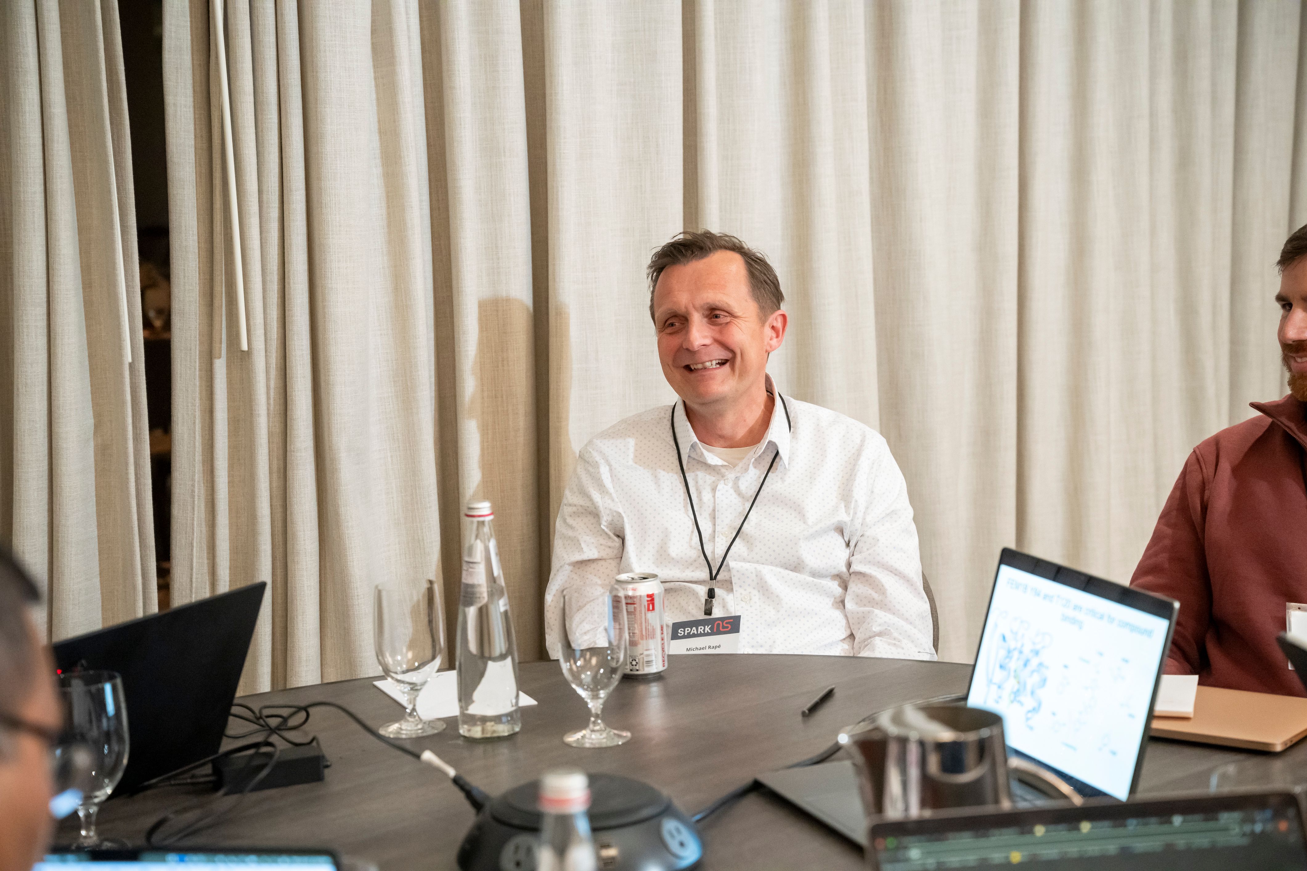 Photo of Michael Rapé, PhD, sitting at a table.