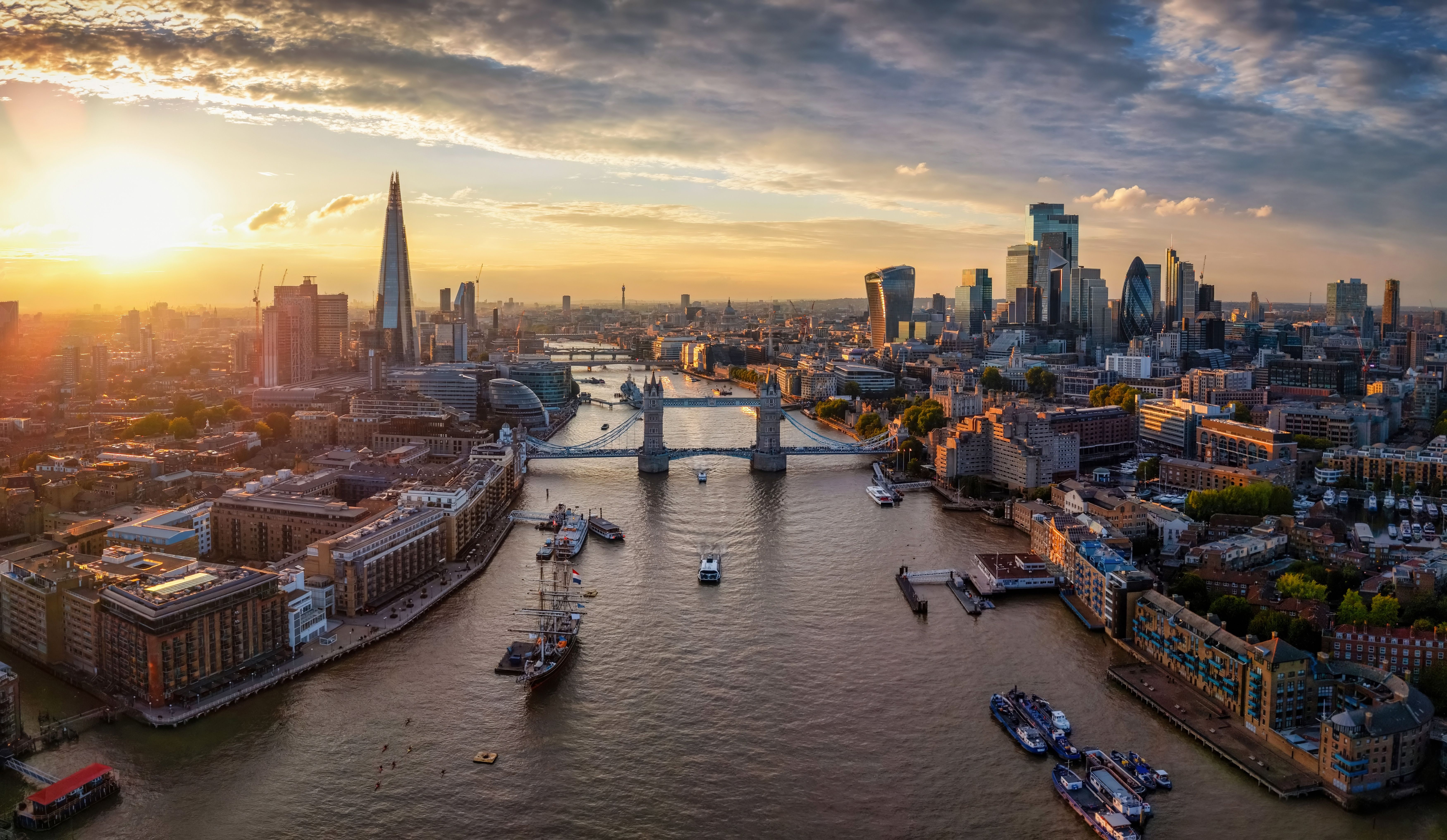 London skyline at sunset, with the River Thames, Tower Bridge, and The Shard.