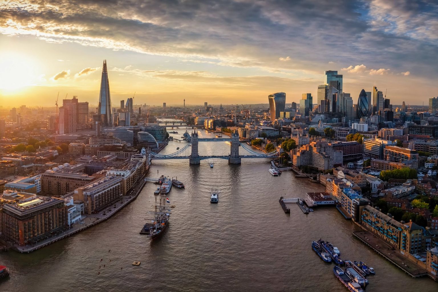 London skyline at sunset, with the River Thames, Tower Bridge, and The Shard.