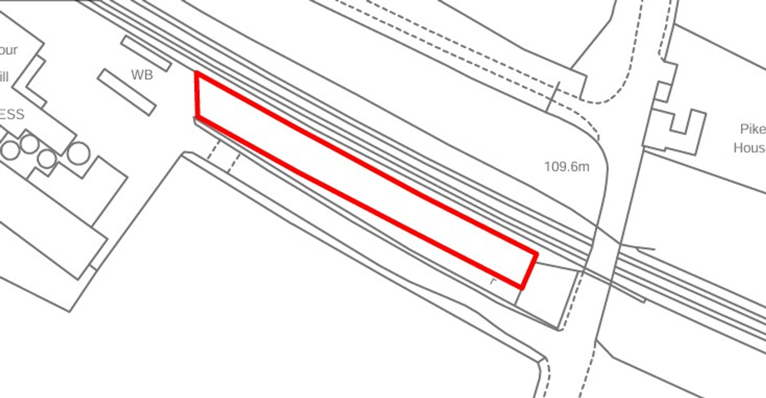 A large plot of land, with fencing around it.