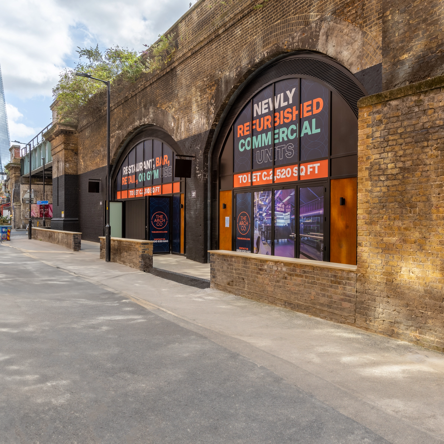 A street scene with brick archways featuring "Newly Refurbished Commercial Units" signs, and The Shard visible in the background.
