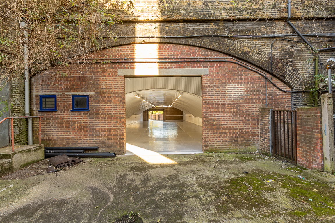 An empty arch with lining and a WC cubicle to the back