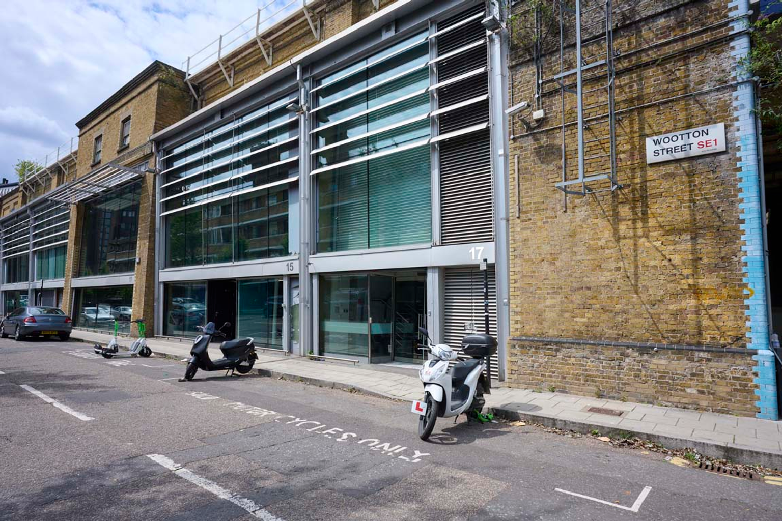 An estate, with multiple warehouse units next to each other. The arches have closed electric roller shutter entrances.