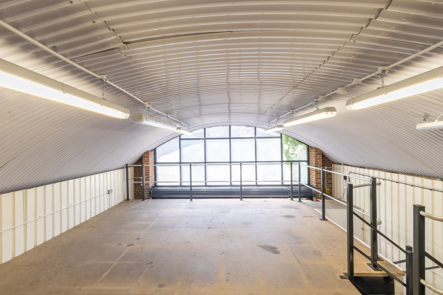 The mezzanine level of an arch with white lining.