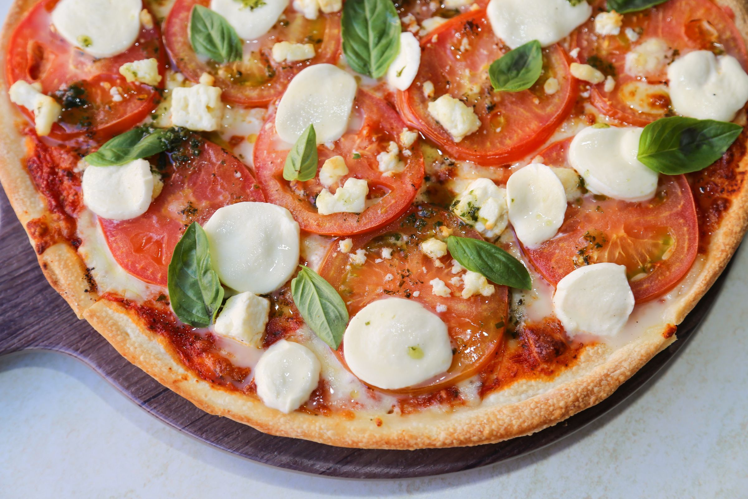 A margherita pizza with tomato, mozzarella and basil