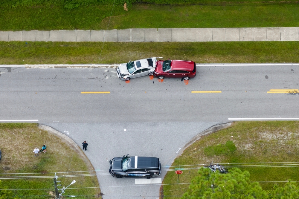 Image An aerial view of a two-car collision on a Pennsylvania roadway with police on scene, illustrating common Thanksgiving travel accidents.