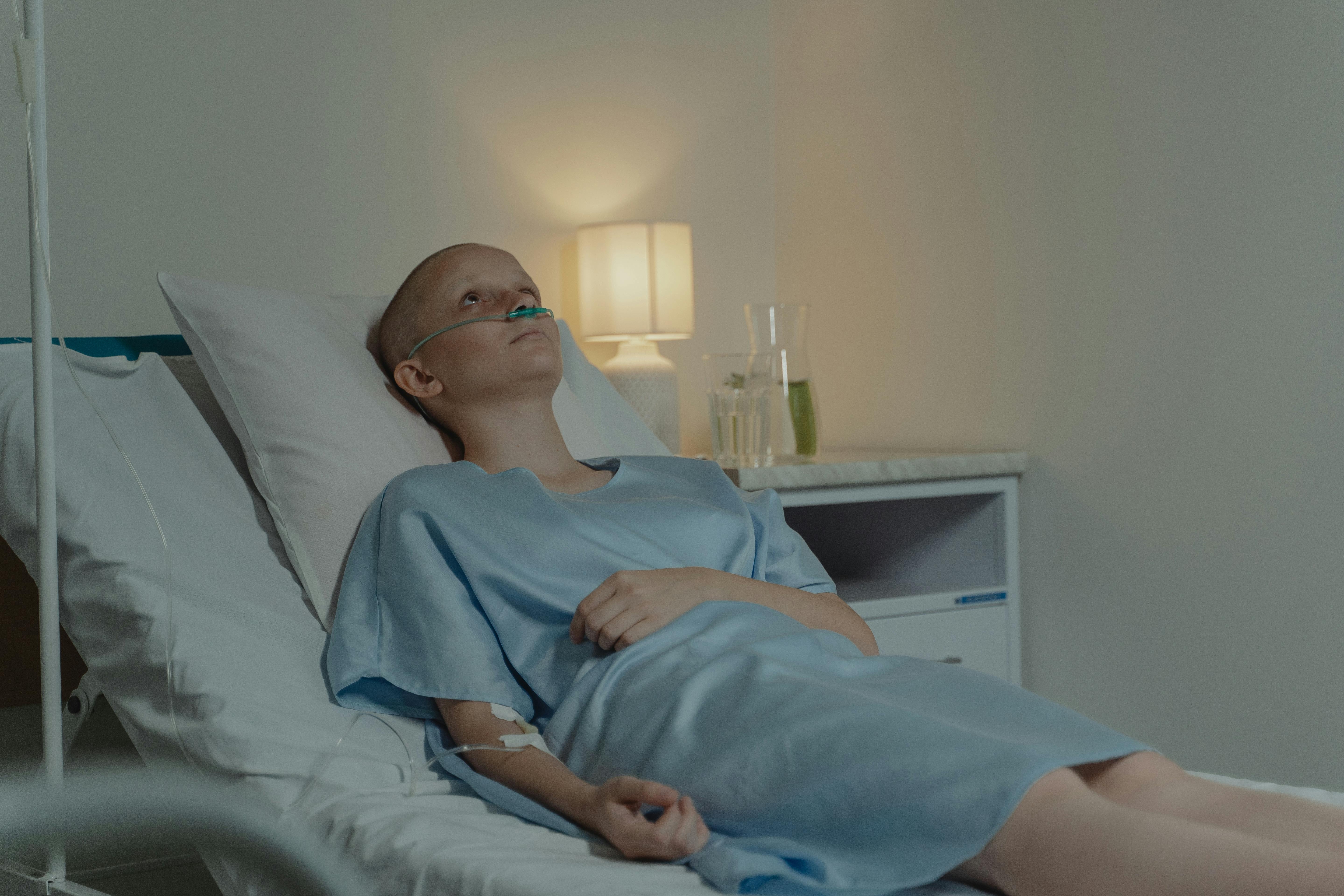 Image Patient lying in a hospital bed during treatment, representing serious defective breast mesh complications after reconstructive surgery.