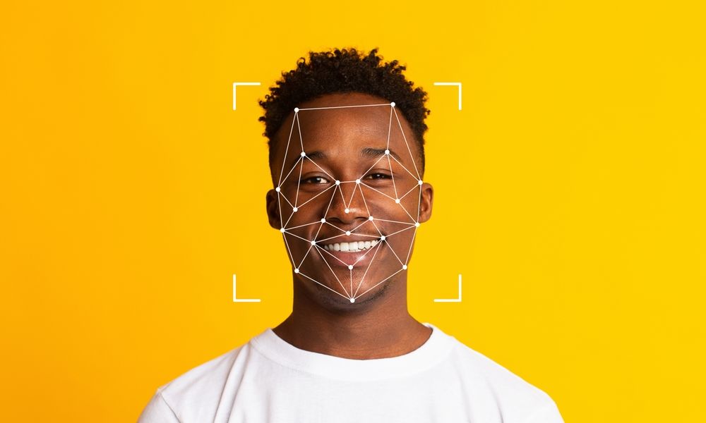Biometric facial age estimation scan on a young man's face for digital identity verification.