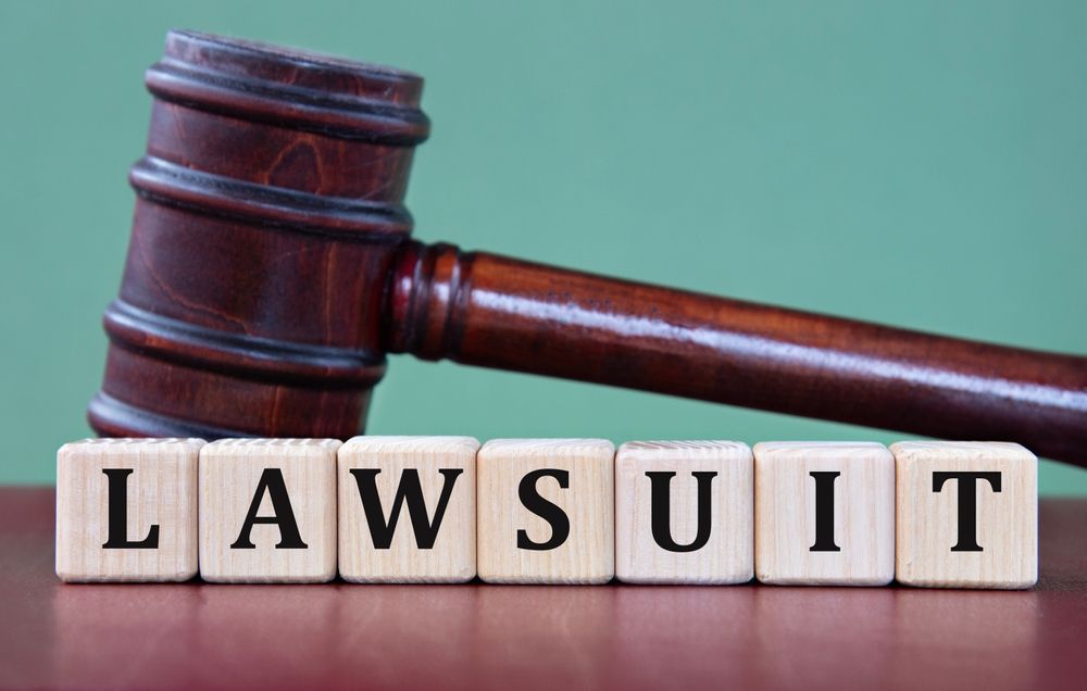 Lawsuit concept image showing a judge’s gavel next to wooden blocks spelling ‘lawsuit,’ symbolizing a Roblox grooming lawsuit.