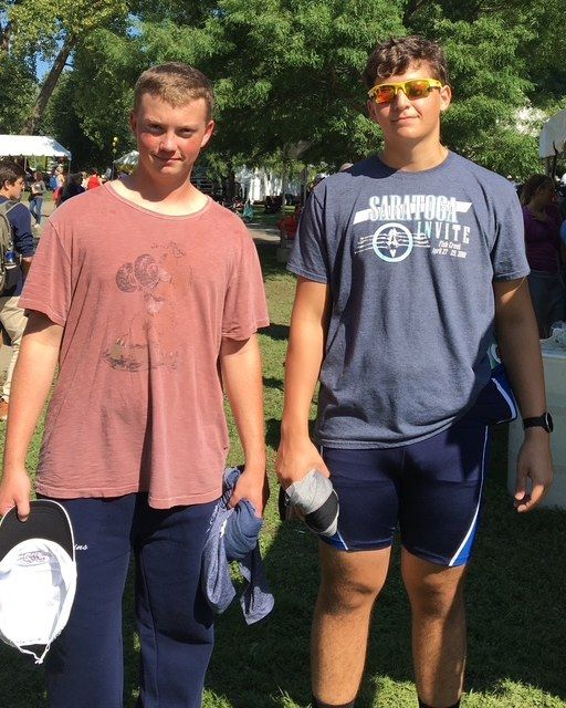 Nick standing with a teammate on the grass at a rowing regatta