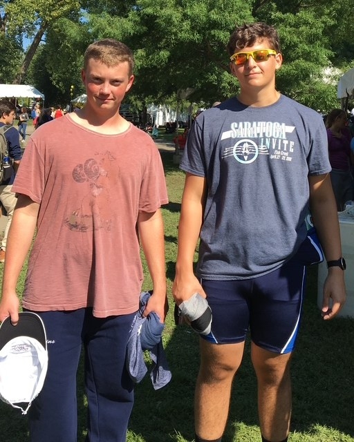 Nick standing with a teammate on the grass at a rowing regatta