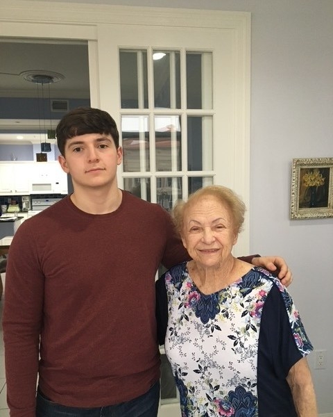 Nick standing with an older woman, his arm around her shoulder