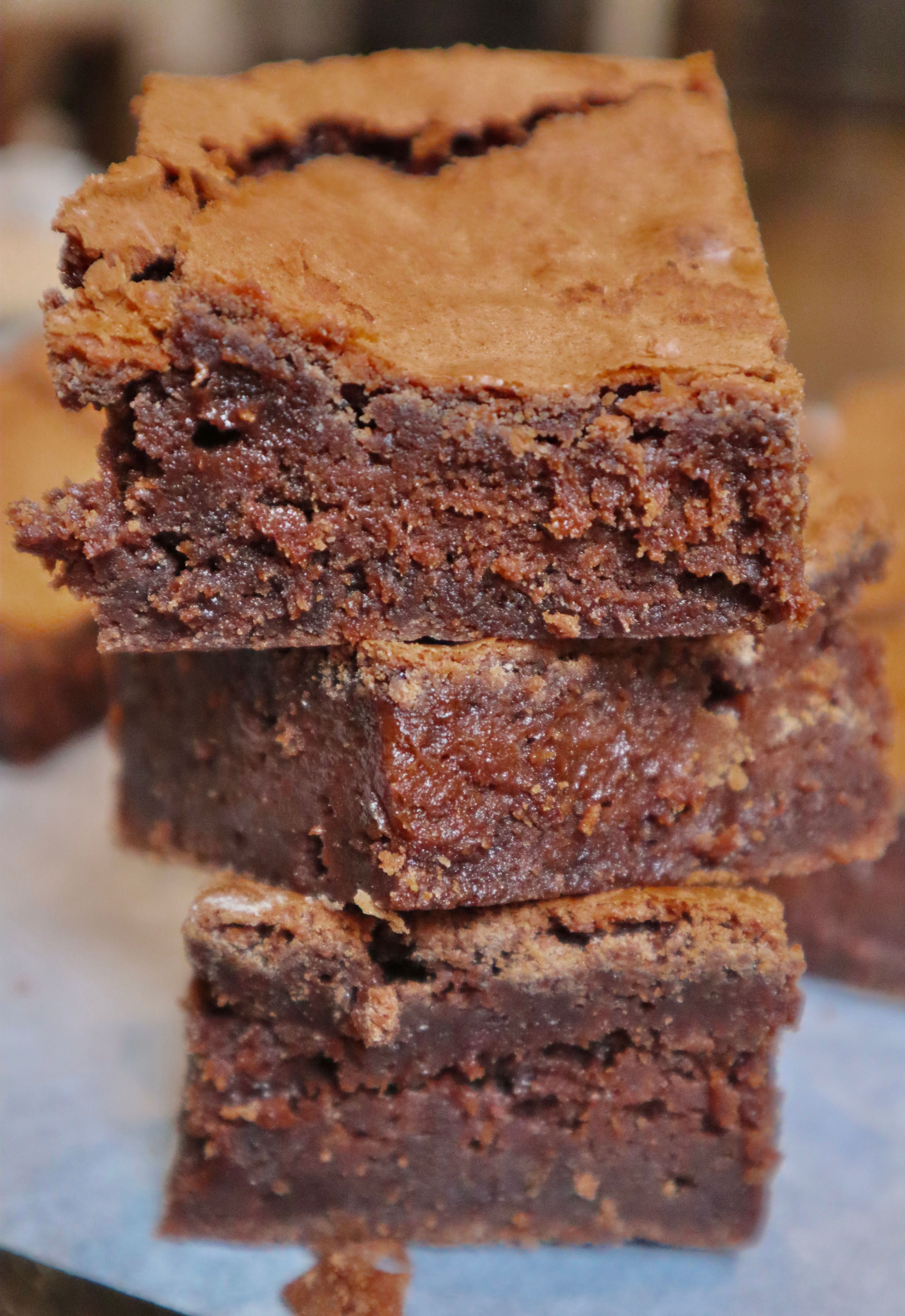Stacked fudgy chocolate brownies with soft center and crackled top