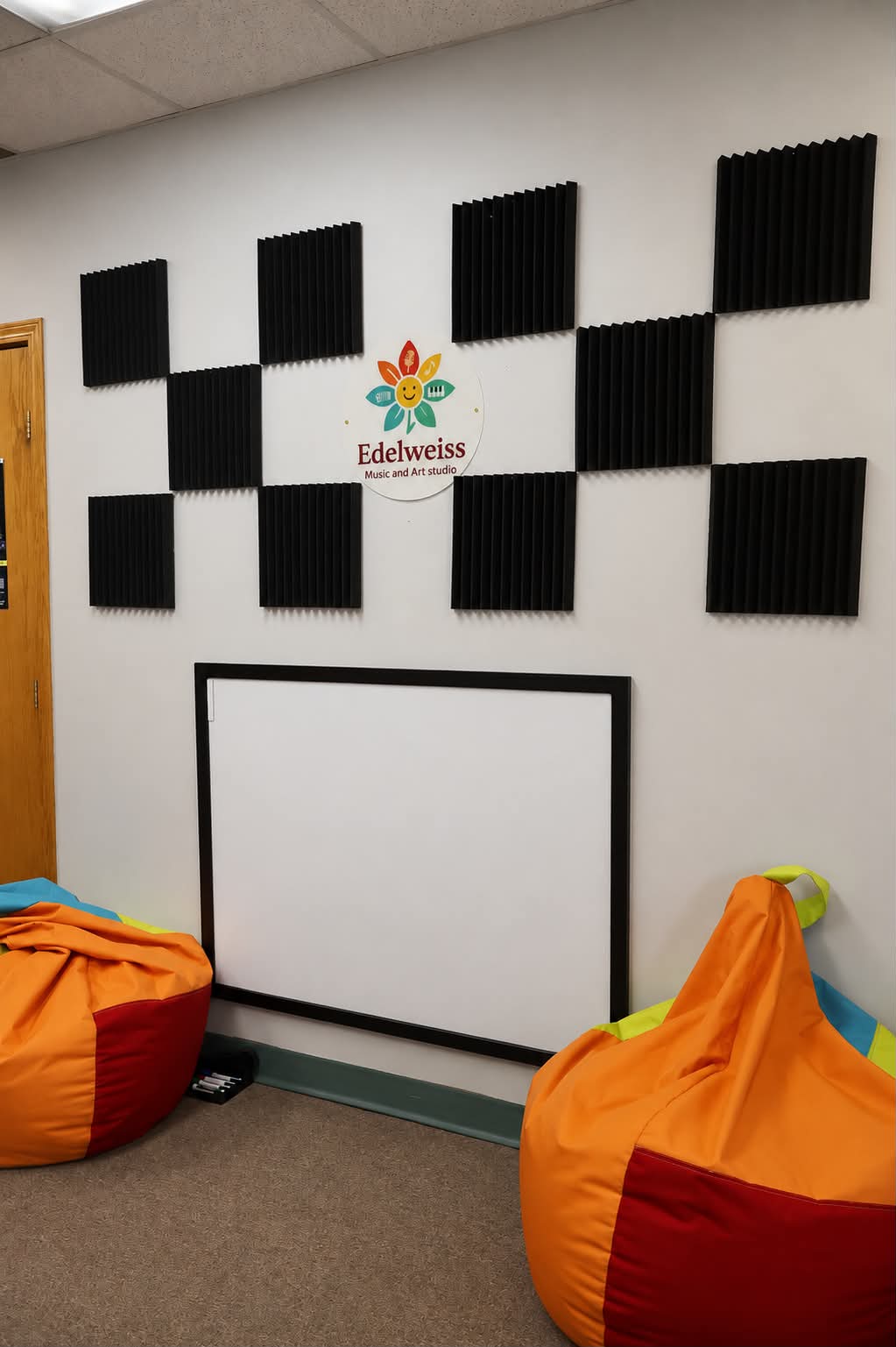 Edelweiss studio teaching room with acoustic wall treatment and seating.
