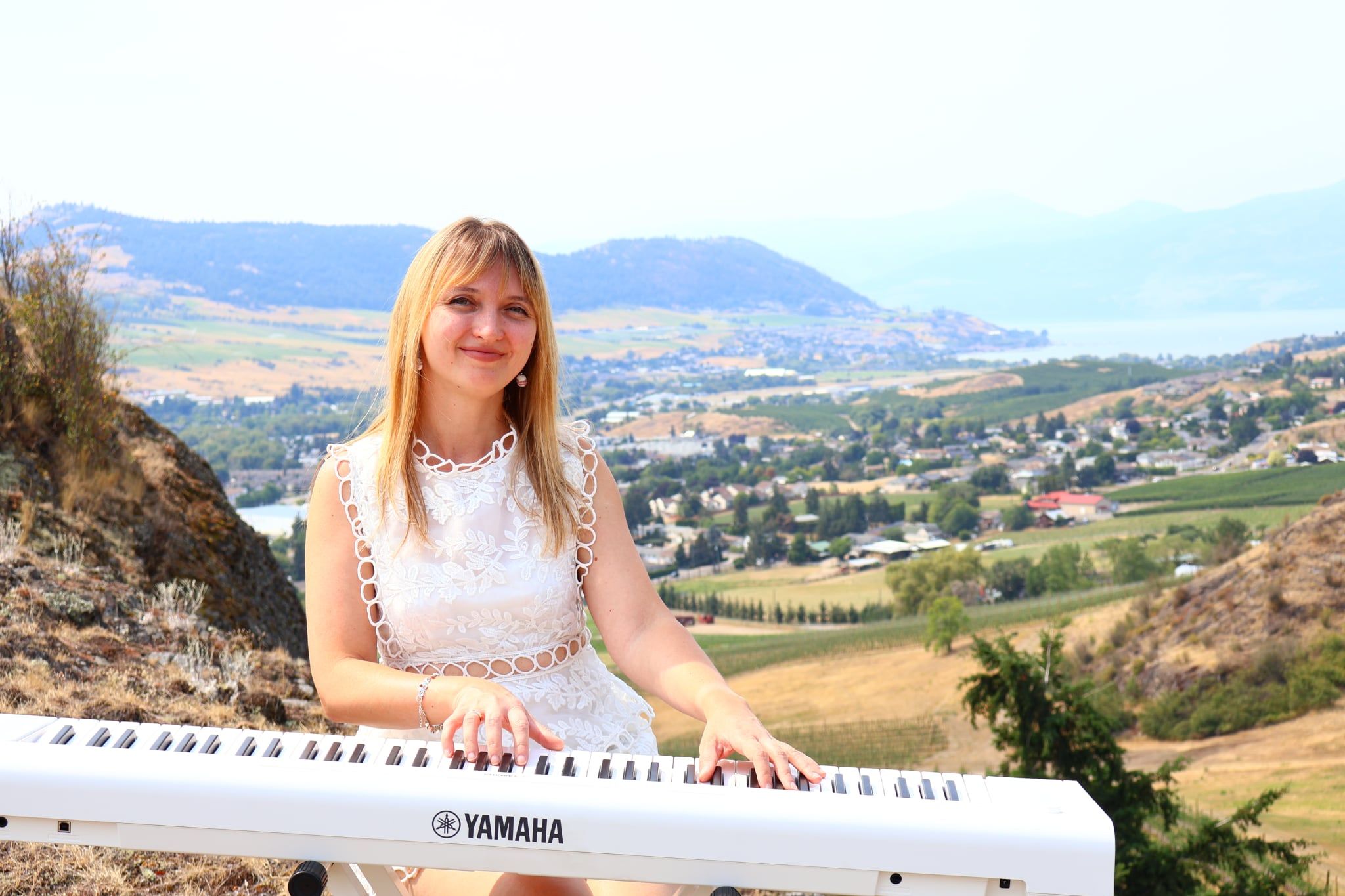 Iryna Viriasova at a Yamaha keyboard overlooking Vernon, British Columbia.